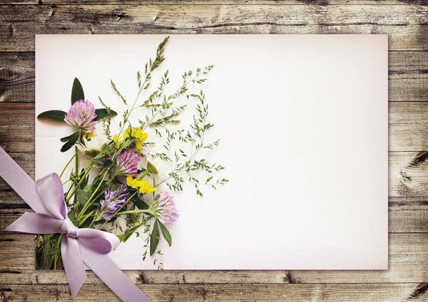 Wild flowers bouquet on white carton