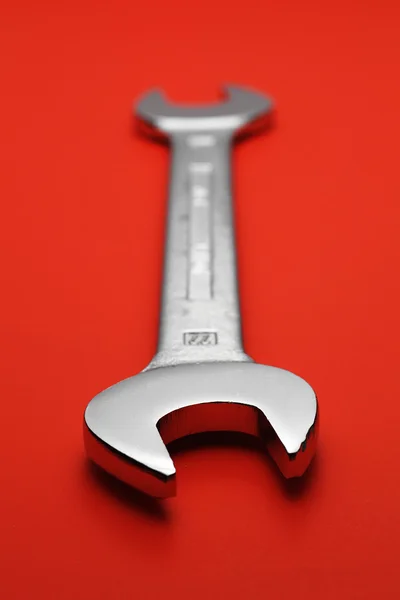 Spanner on red background
