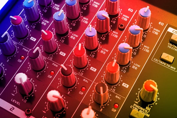 Dj mixing console under disco lights