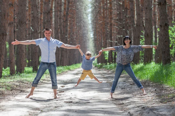 Happy family walking in the forest