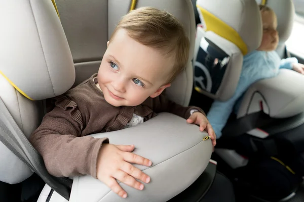 Adorable baby in safety car seat