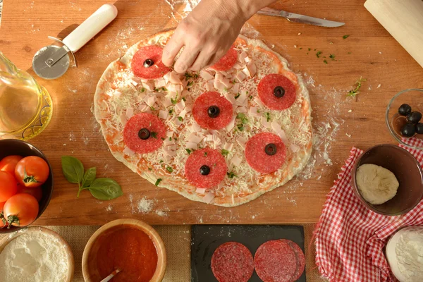 Woman hands cooking pizza at home