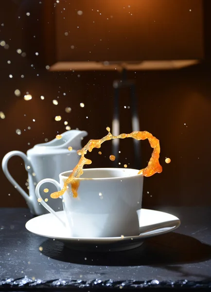 Splash of hot coffee in a cup