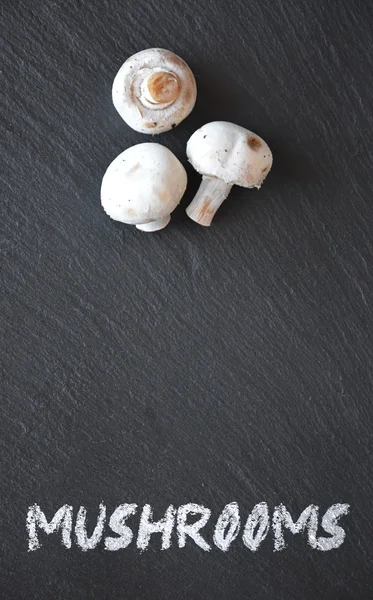 Mushrooms on a black slate table