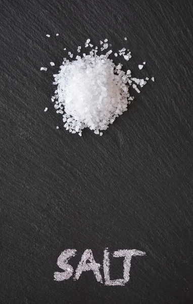 Coarse salt on a black slate table