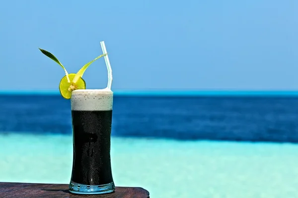 Black drink on a beach