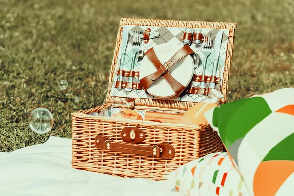 Picnic Basket Food On White Blanket With Pillows And Soap Bubbles