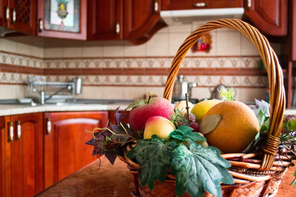 Interior of a wooden kitchen. Decorative basket with fruits on table