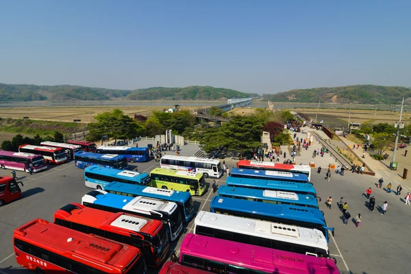 Hills of North Korea afar and lots of tourist buses at the South Korea side