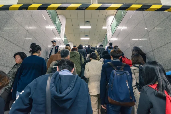 Crowd of people making their way to the metro station on a busy hour in Seoul, Korea