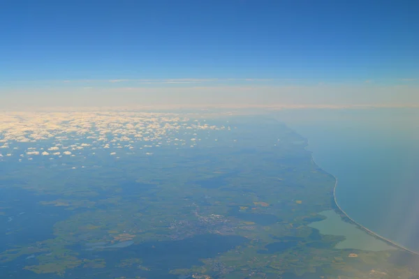 Aerial view of the ocean and land coast from the sky