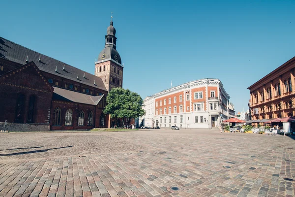 RIGA, LATVIA - CIRCA JULY 2014: old square with church in the old town in Riga, Latvia on a sunny warm day in July 2014.