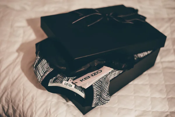 MOSCOW - CIRCA 2015: delivery of a green sweater by Kenzo in a luxe black box.