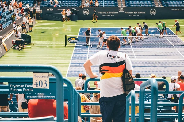 CINCINNATI, OH - CIRCA 2011: court workers after sudden rain at Lindner Family Tennis Center on Western & Southern Open tournament finals in Cincinnati, OH, USA at summer 2011.