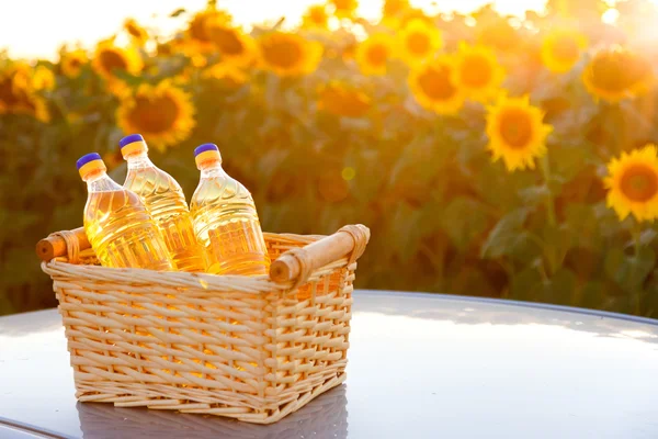 Wicker basket with three bottles of sunflower oil.