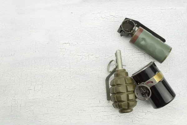 Hand grenade on shadowed, cracked background. War game. Sales of weapons.