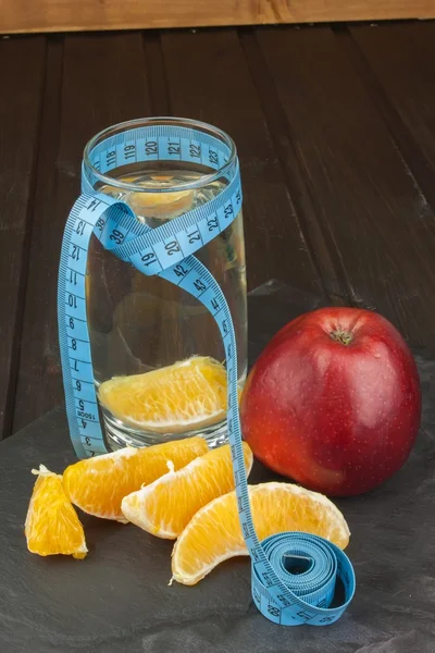 Glasses of water and fruit. Food for weight reduction. Diet program. Controlled diet. Healthy diet for athletes. Diet food. Fruity breakfast.