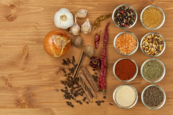 The joy of cooking, preparation of spices. Various kinds of spices on a wooden board. Food preparation. Spices on the kitchen table.