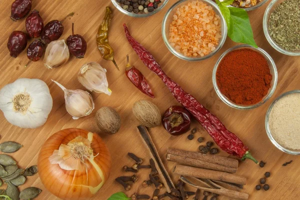 The joy of cooking, preparation of spices. Various kinds of spices on a wooden board. Food preparation. Spices on the kitchen table.