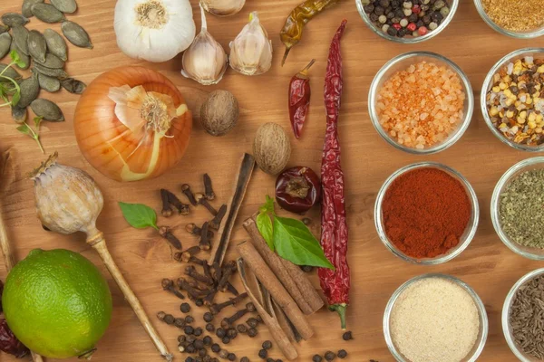 The joy of cooking, preparation of spices. Various kinds of spices on a wooden board. Food preparation. Spices on the kitchen table.