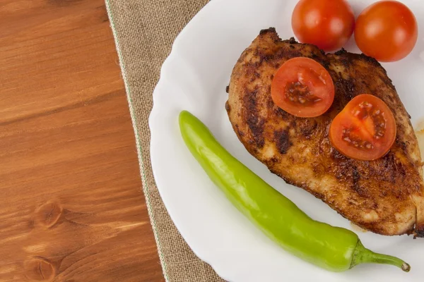 Chicken steak with vegetables. Grilled chicken breasts. Dietary meat on the grill. Chicken fried steak.