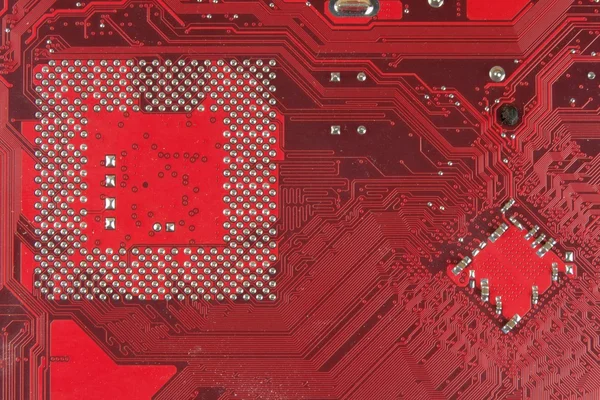 Closeup electronic circuit board dirty. omputer board with chips and components. Computer red Motherboard Close Up