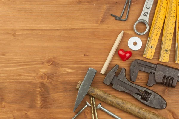 Set of tools and instruments on wooden background. Different kinds of tools for household chores. Home repairs. Father\'s Day.