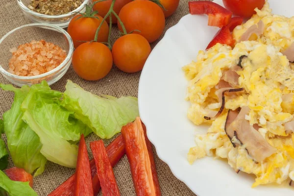 Fresh scrambled eggs with bacon and vegetables. Domestic eggs for breakfast. Breakfast athletes. Preparing eggs. Protein diet. Eggs in different kinds of preparations.