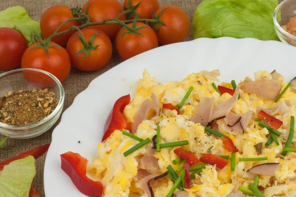 Fresh scrambled eggs with bacon and vegetables. Domestic eggs for breakfast. Breakfast athletes. Preparing eggs. Protein diet. Eggs in different kinds of preparations.