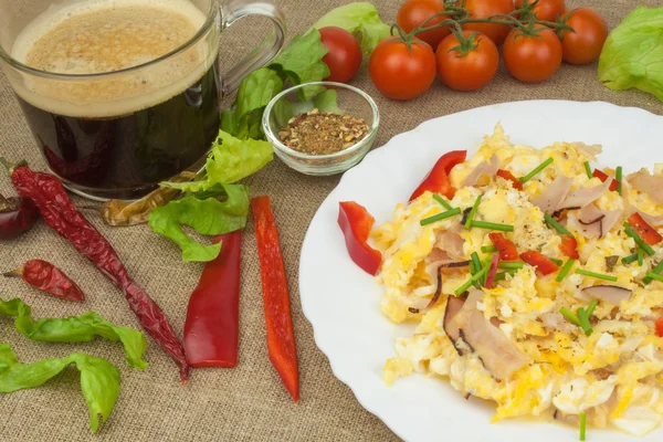 Homemade breakfast with a cup of coffee.Fresh scrambled eggs with bacon and vegetables. Breakfast athletes. Preparing eggs. Protein diet. Eggs in different kinds of preparations.