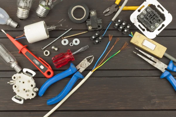 Clutter on the workbench. Tools, electronics repairman. Repair of household electrical equipment. Sales of electronics components. Advertising on servicemen.