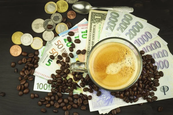 Global trade coffee. Cup of coffee and money. Valid banknotes on a wooden table. The problem of corruption. Trading in roasted coffee. Investing in the coffee trade.