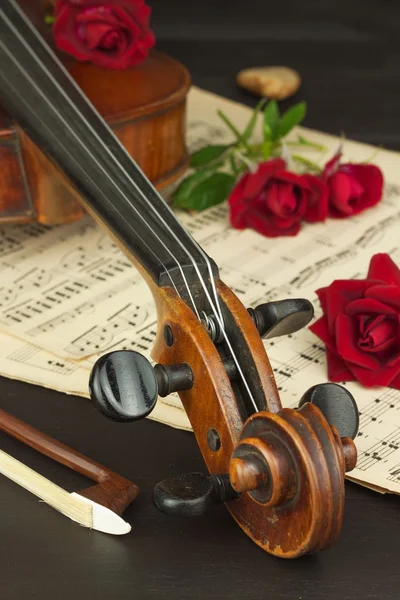 Old violin on wooden table. Detail of old violin. Invitation to the Violin Concerto. I love classical music. Sale of antique violins.