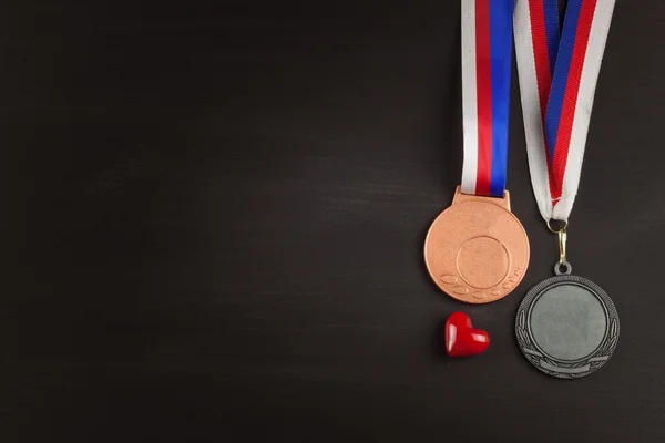 Sports medals on a wooden background. Collection of medals for the winners. Awards in sports.
