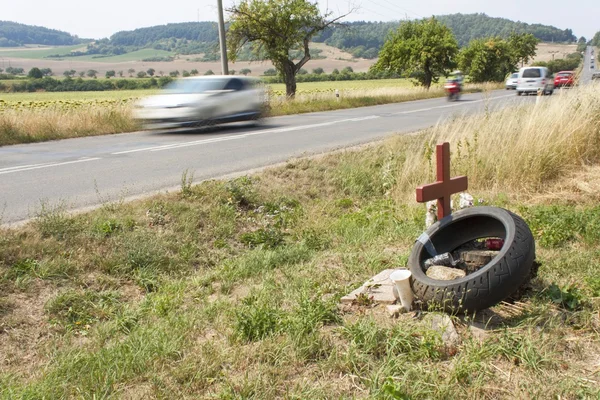 Memorial site a real tragic traffic accident on a country road. Instead of the death of motorcyclists. Dangerous deadly speed. The danger of accidents. Speeding on the roads. Monument near the road.