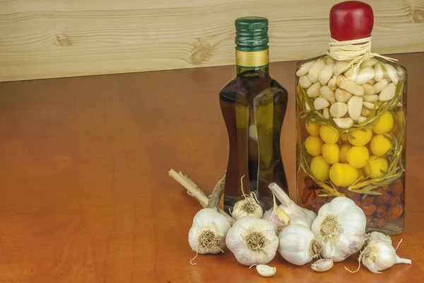 Garlic, aromatic ingredients for flavoring food. Home remedy for colds and flu. Garlic marinated in olive oil. Seasoning food. Preparing for the garden party and barbecue meat.