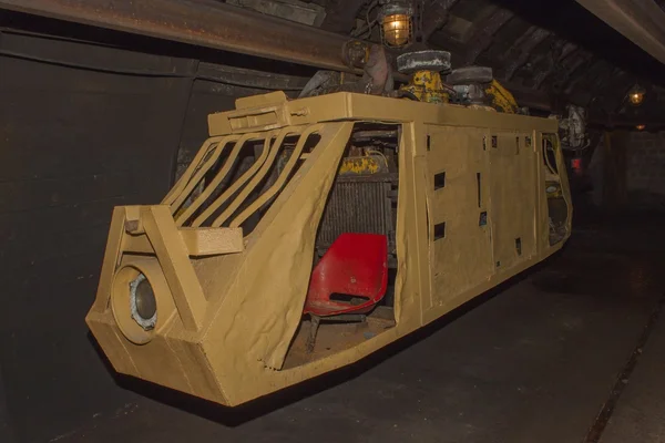 An old, abandoned coal mine and mine train. Coal mining in the underground mine. Mining train to transport miners to the point of extraction. Underground transport.