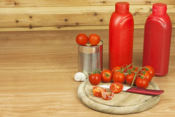 Fresh tomatoes on the kitchen table. Tomatoes on a wooden cutting board. Domestic cultivation of vegetables. Fresh organic food ready to cook. Fresh dietary ingredients. Raw vegetables to raw food.