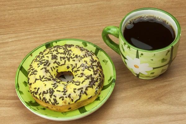 Sweet donut with coffee. Sweet treat with coffee. Donut as quick homemade treats. Junk food diets enemy. A symbol of junk food and obesity, donut for a snack.