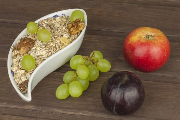 Healthy Diet breakfast of oatmeal, cereal and fruit. Foods full of energy for athletes. The concept of diet food. Preparing homemade breakfast. Vegetarian diet.