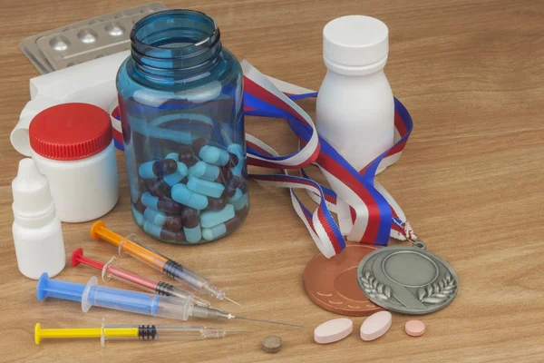 Doping in sport. Abuse of anabolic steroids for sports. Anabolic steroids spilled on a wooden table. Fraud in sports. Pharmaceutical industry. Detailed view of the medication. Place for your text.