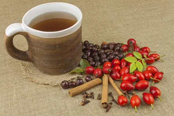 A flu epidemic. Traditional home treatment for colds and flu. Rosehip tea, honey and citrus. Hot tea with honey and lemon on a tabletop. Home Pharmacy. Proven treatment of diseases.