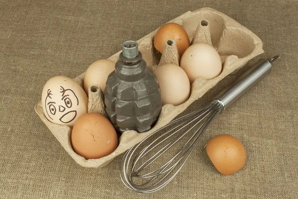 Hand grenade - an egg. Grenade between eggs. Explosive eggs, funny picture. Homemade chicken eggs. Traditional food with protein. Eggs on the table, food preparation. Preparing egg omelet.