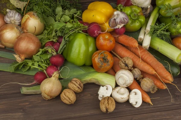 Various types of vegetables on an old wooden table. The concept of diet food. Food for obese patients. Autumn harvest vegetables. Growing fresh home-grown vegetables.