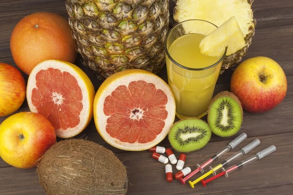 Dietary supplements for weight loss. Red grapefruit and fruit for weight loss. Fresh dietary food for athletes. Fruit on a wooden table.Balanced diet. Assortment of exotic fruits.