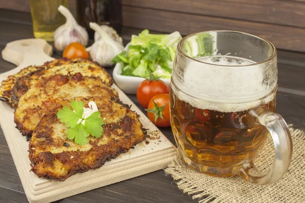 Fried potato pancakes with garlic. Traditional Czech food. Preparing homemade food. Potato pancakes and beer glasses.