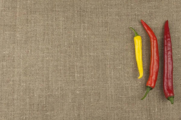 Chili peppers on table. Homework spicy food. Decorations for the menu. Place for text. Fresh chilli on old wood background.