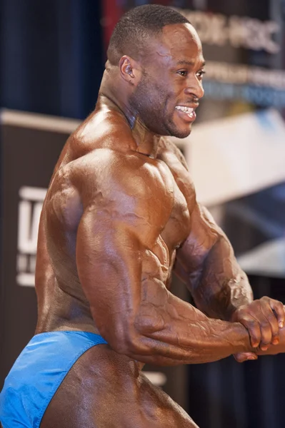 Male bodybuilder Michael Muzo shows his chest pose