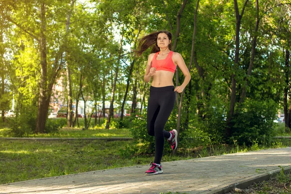 Running woman in park in summer training