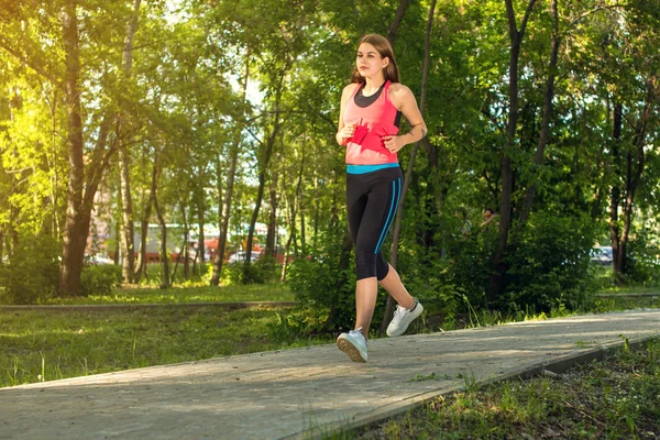 Running woman in park in summer training